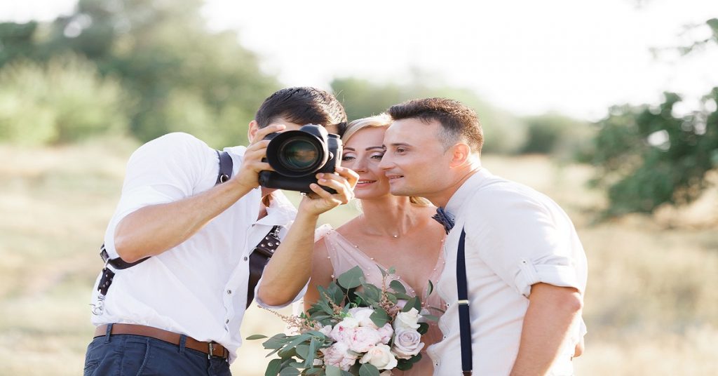 Wedding Photographer Takes Pictures Of Bride And Groom